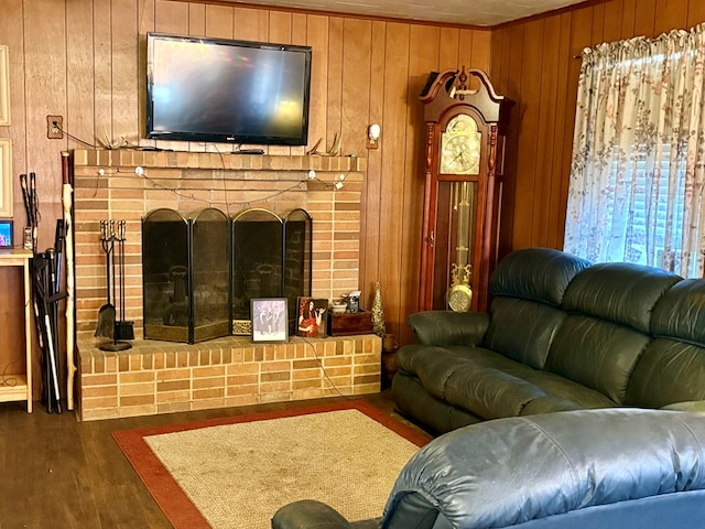 living room with wood walls, dark hardwood / wood-style flooring, and a fireplace