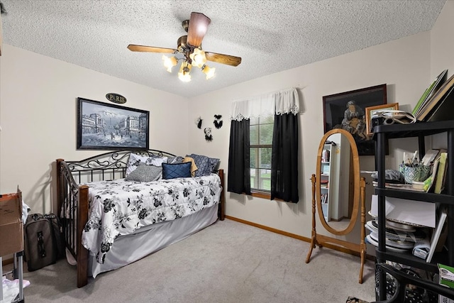 bedroom featuring carpet, ceiling fan, and a textured ceiling