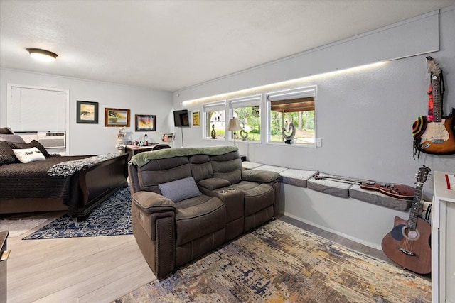 living room featuring hardwood / wood-style floors and a wall mounted air conditioner