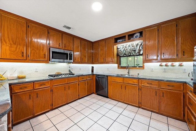 kitchen featuring light tile patterned floors, stainless steel appliances, tasteful backsplash, and sink