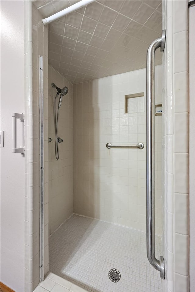 bathroom with tile patterned flooring and a shower with door