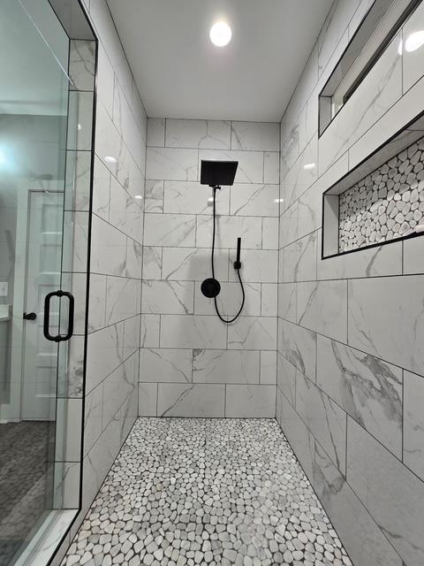 full bath with a shower stall