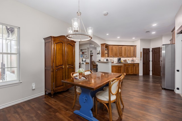 dining space featuring dark wood-type flooring and sink