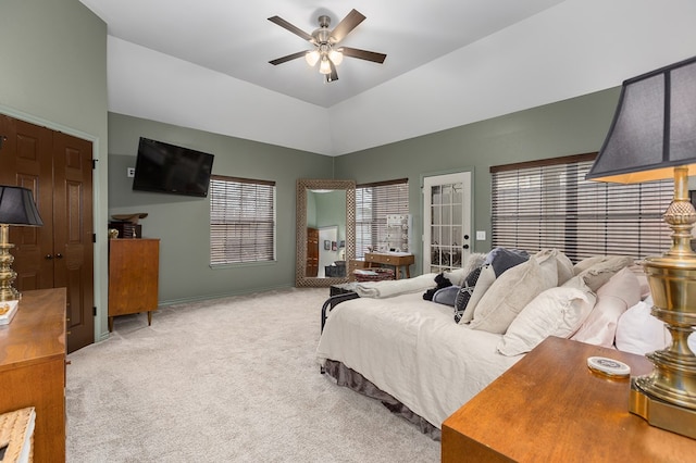 carpeted bedroom with ceiling fan and vaulted ceiling