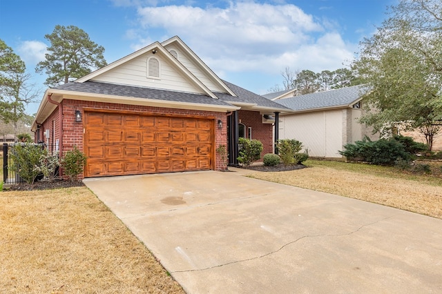 view of front of house featuring a garage and a front lawn