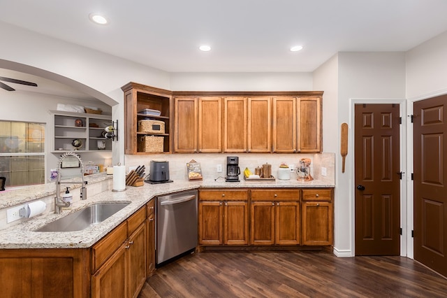 kitchen featuring tasteful backsplash, dishwasher, light stone countertops, and dark wood-type flooring