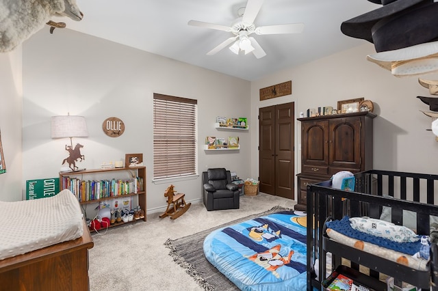 bedroom featuring ceiling fan, light colored carpet, and a closet