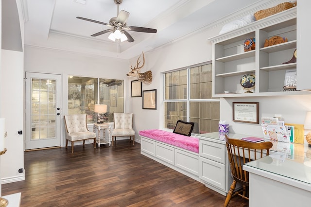 living area with dark hardwood / wood-style floors, ornamental molding, a raised ceiling, and ceiling fan