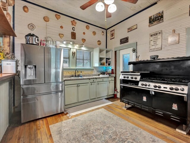 203 Chandler St, Diboll, TX 75941 - kitchen featuring stainless steel fridge with ice dispenser, double oven range, ceiling fan, and light wood-style flooring