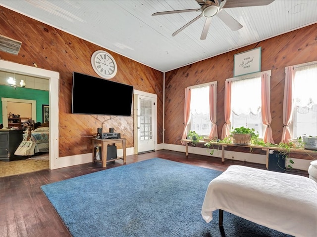 203 Chandler St, Diboll, TX 75941 - bedroom featuring wooden walls, multiple windows, wood finished floors, a chandelier, and vaulted ceiling