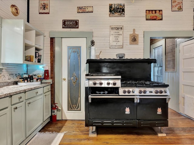 203 Chandler St, Diboll, TX 75941 - kitchen featuring open shelves, light wood-style floors, double oven range, and light countertops