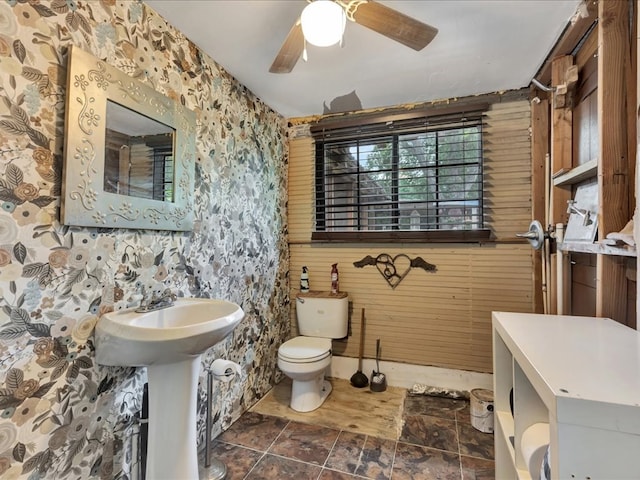 203 Chandler St, Diboll, TX 75941 - bathroom featuring wood walls, a ceiling fan, and stone finish floors
