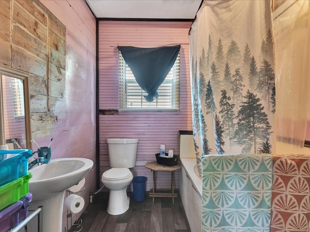 203 Chandler St, Diboll, TX 75941 - bathroom with wood walls, wood finished floors, and tiled shower / bath