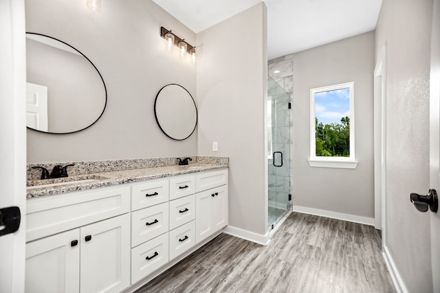 2510 Jimmie, Lufkin, TX 74904 - full bath with double vanity, a shower stall, baseboards, and wood finished floors