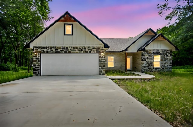 2510 Jimmie, Lufkin, TX 74904 - view of front facade featuring stone siding, board and batten siding, concrete driveway, and a garage