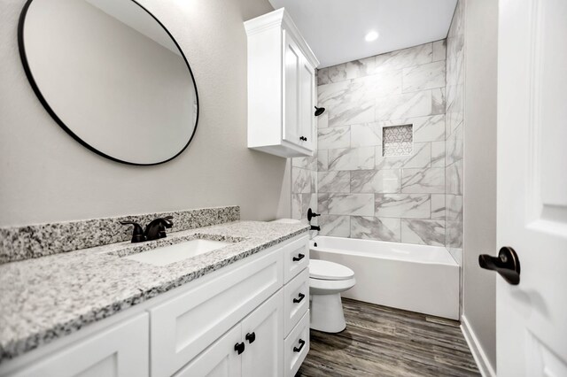 2510 Jimmie, Lufkin, TX 74904 - bathroom featuring vanity, toilet, recessed lighting, wood finished floors, and shower / bathtub combination