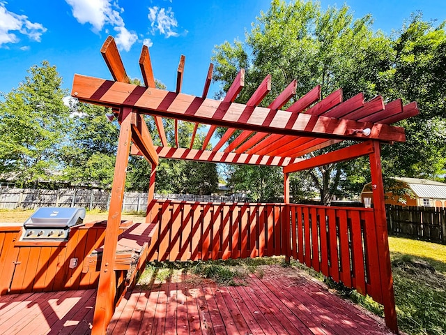 wooden deck featuring a pergola and area for grilling