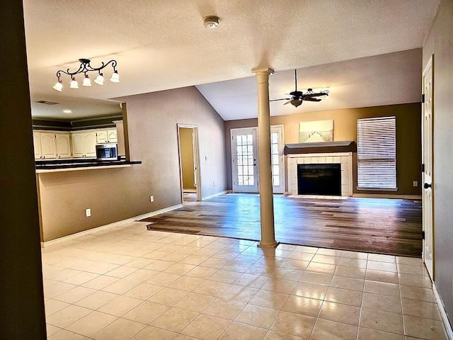 unfurnished living room with a fireplace, light hardwood / wood-style flooring, ceiling fan, and lofted ceiling