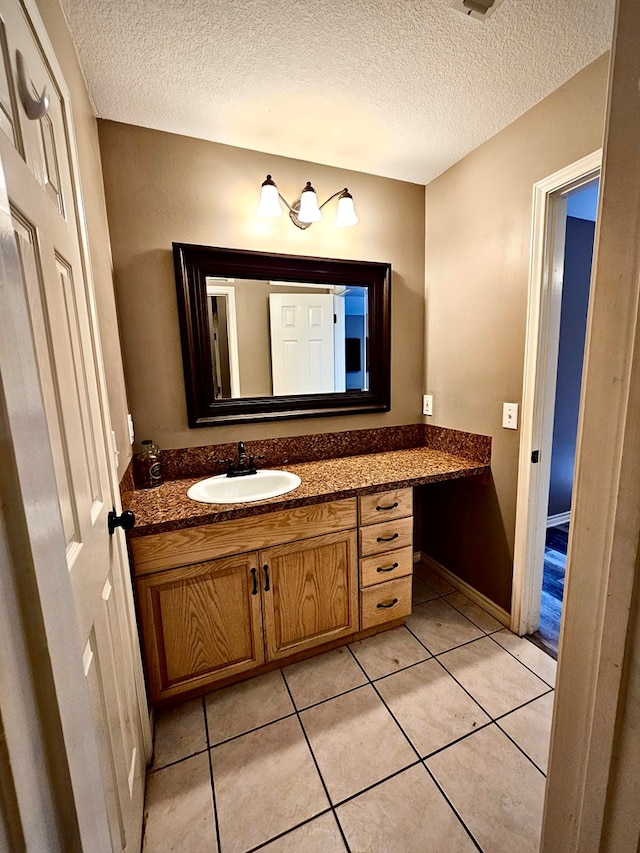 bathroom featuring tile patterned floors, vanity, and a textured ceiling