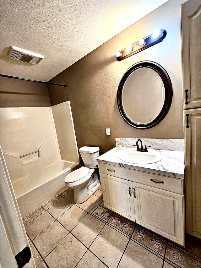 full bathroom featuring vanity, a textured ceiling, washtub / shower combination, tile patterned flooring, and toilet