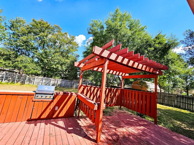 wooden deck with a yard, a pergola, and grilling area