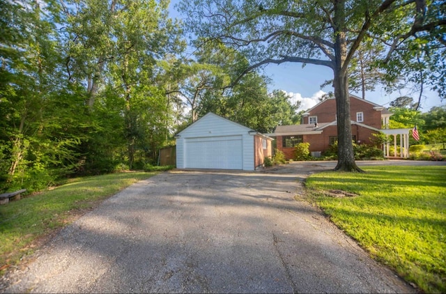 view of front of house featuring a front lawn, a garage, and brick siding