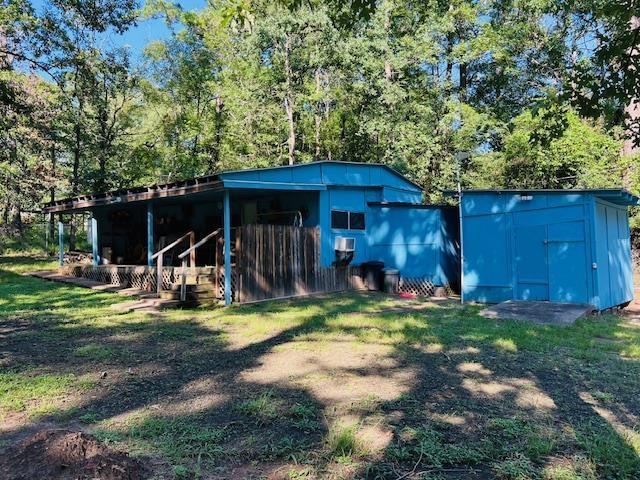 view of outbuilding featuring a yard