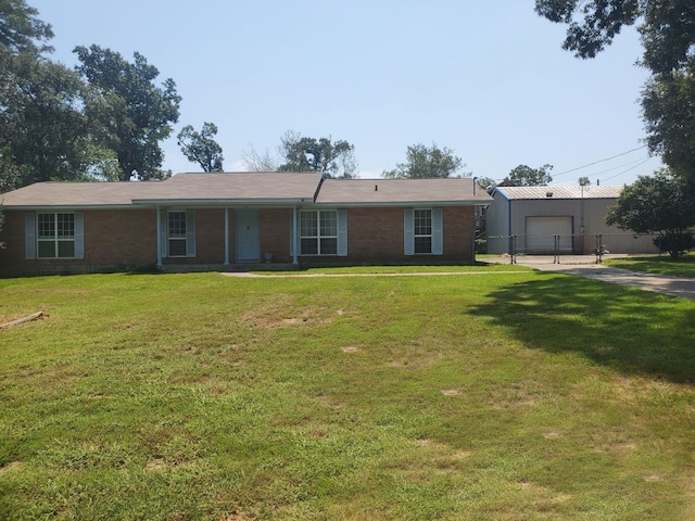 single story home featuring a garage and a front lawn