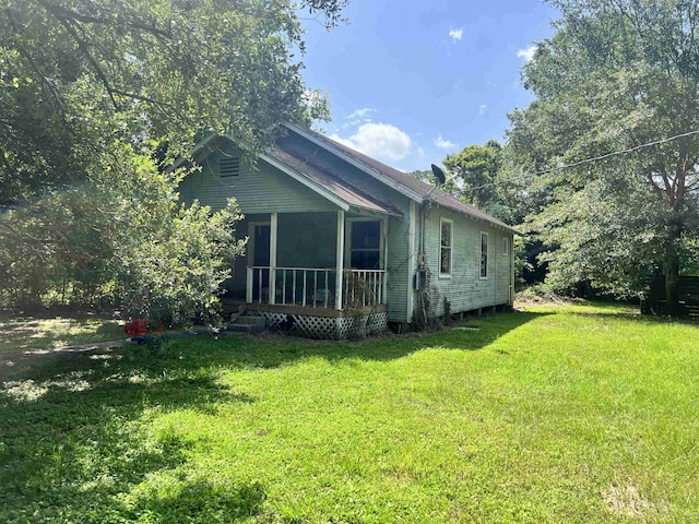 view of property exterior with a lawn and a sunroom