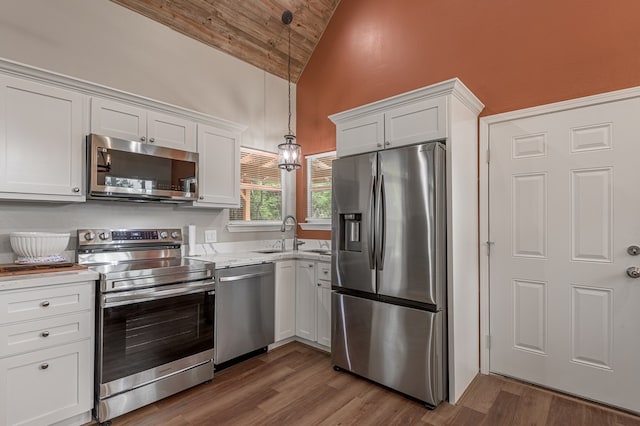 kitchen featuring wood ceiling, white cabinetry, a sink, stainless steel appliances, and hanging light fixtures