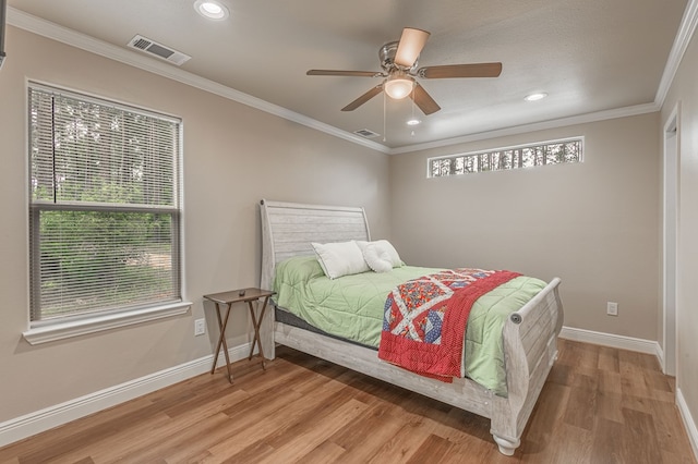 bedroom featuring crown molding, light wood-style flooring, visible vents, baseboards, and recessed lighting