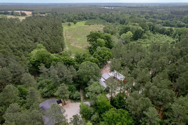 birds eye view of property with a view of trees