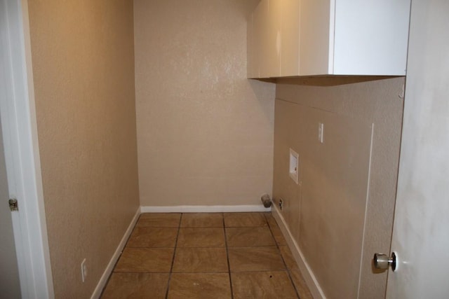 washroom with cabinets, hookup for a washing machine, and tile patterned floors