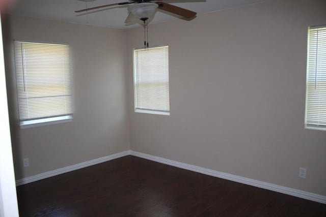 empty room featuring ceiling fan and dark hardwood / wood-style flooring