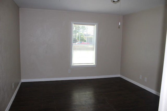 empty room with dark hardwood / wood-style floors