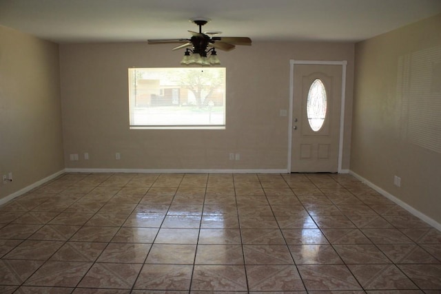 foyer with light tile patterned floors, plenty of natural light, and ceiling fan