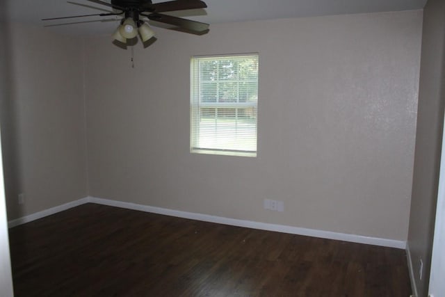 spare room with ceiling fan and dark hardwood / wood-style flooring