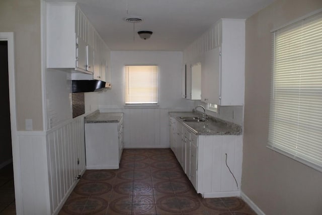 kitchen featuring a wealth of natural light, white cabinetry, and sink