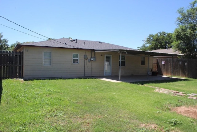 rear view of property with a patio area and a yard