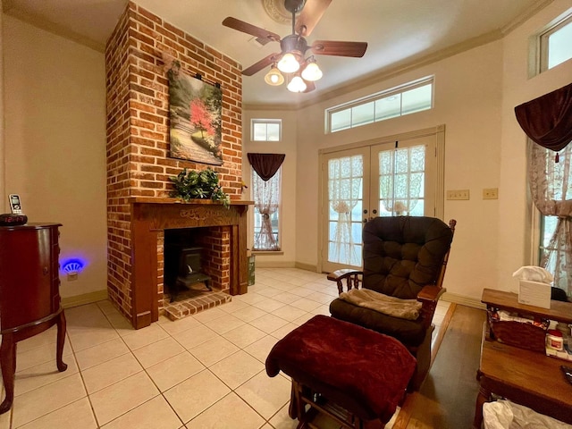 sitting room with plenty of natural light, light tile patterned flooring, french doors, and ornamental molding