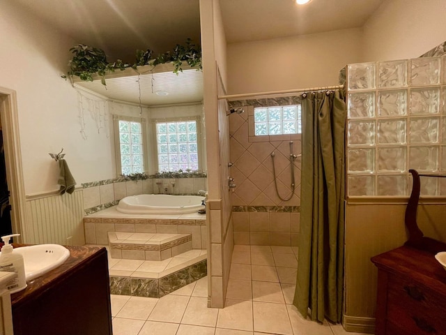 bathroom with tile patterned flooring, vanity, and separate shower and tub