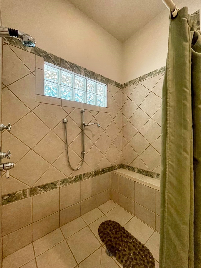 bathroom with tile patterned floors and curtained shower