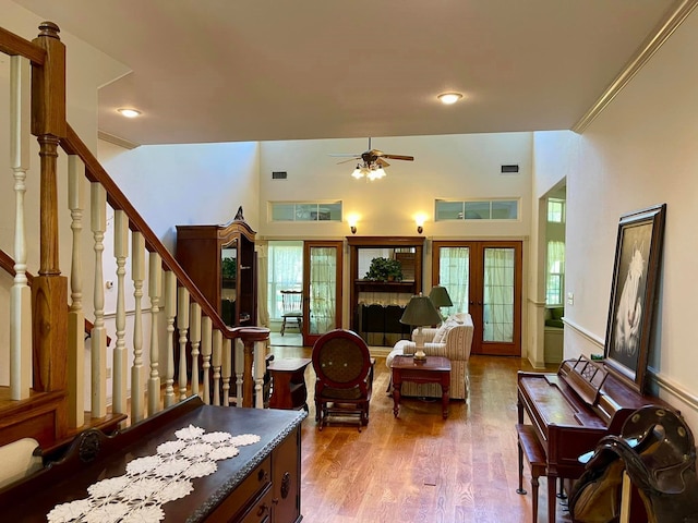 living room featuring french doors, ceiling fan, and wood-type flooring