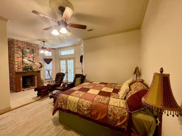 bedroom with ceiling fan, french doors, a fireplace, light tile patterned floors, and ornamental molding