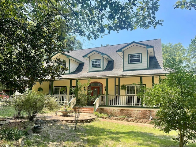 cape cod-style house featuring covered porch