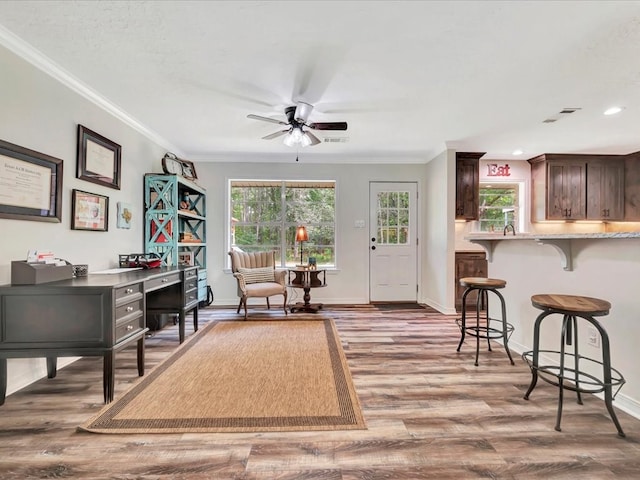 office area with ceiling fan, ornamental molding, light wood-type flooring, and baseboards