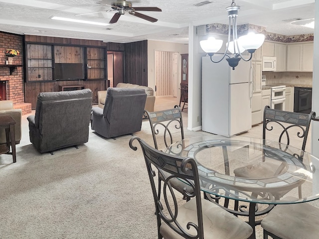 906 Richardson Dr, Jasper, TX 75951 - dining area featuring a textured ceiling, a ceiling fan, a chandelier, and a brick fireplace