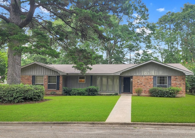 906 Richardson Dr, Jasper, TX 75951 - single story home featuring brick siding, board and batten siding, and a front yard