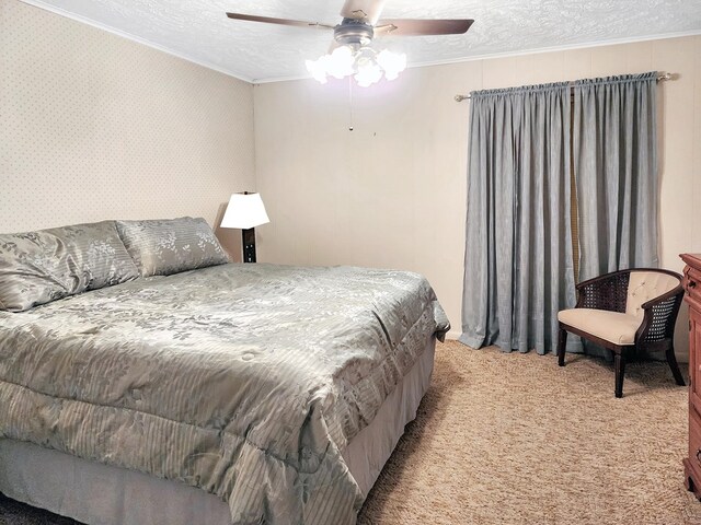 906 Richardson Dr, Jasper, TX 75951 - bedroom with crown molding, light colored carpet, a textured ceiling, and a ceiling fan