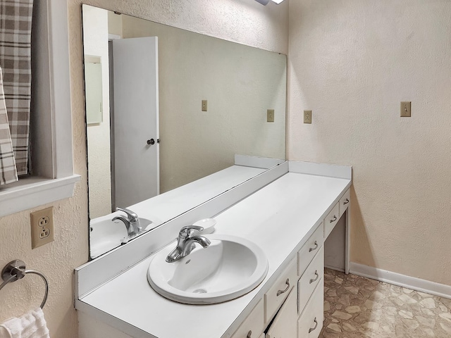 906 Richardson Dr, Jasper, TX 75951 - bathroom featuring vanity and a textured wall